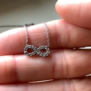 Silver infinity necklace.